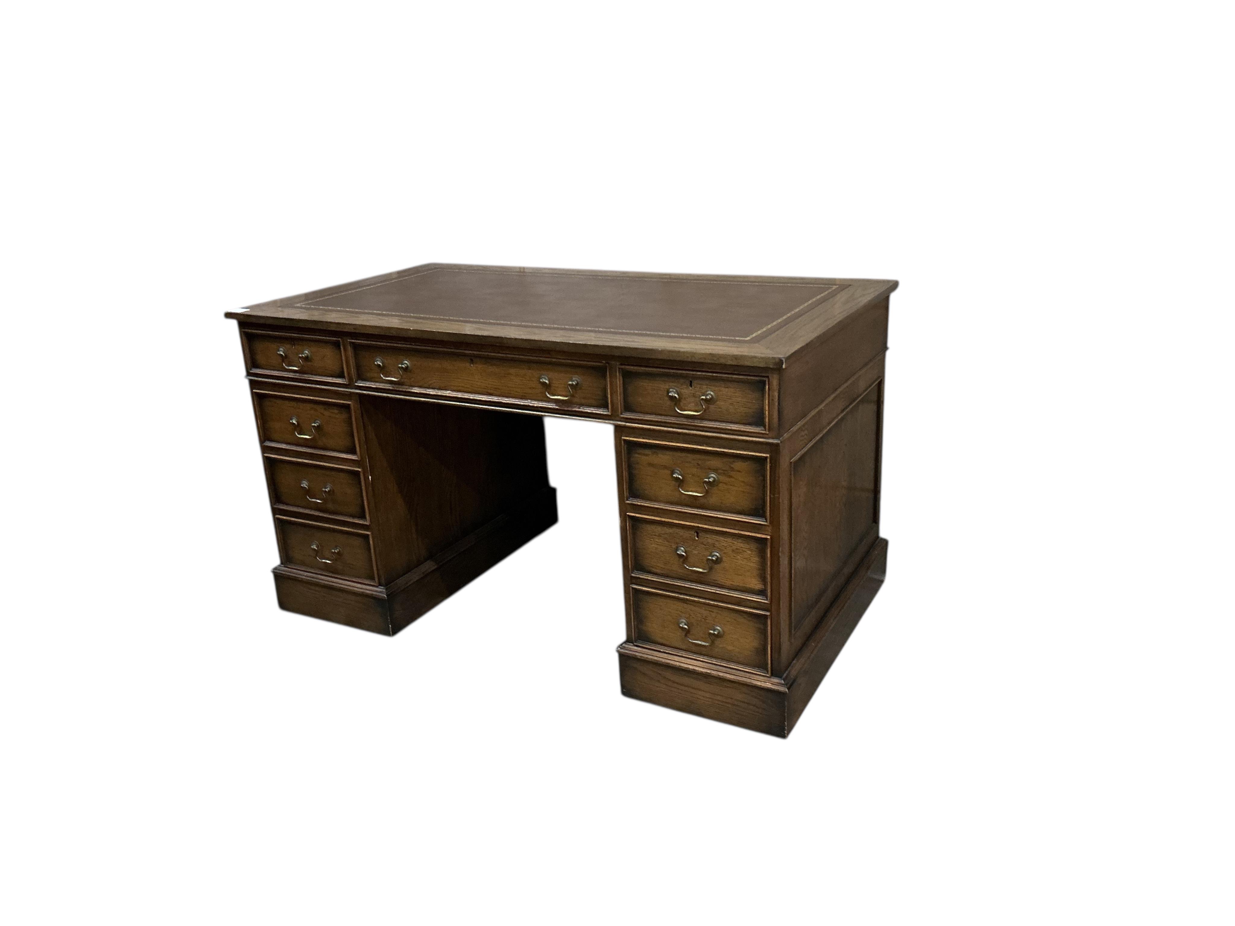A reproduction oak pedestal desk, width 137cm, depth 76cm, height 78cm